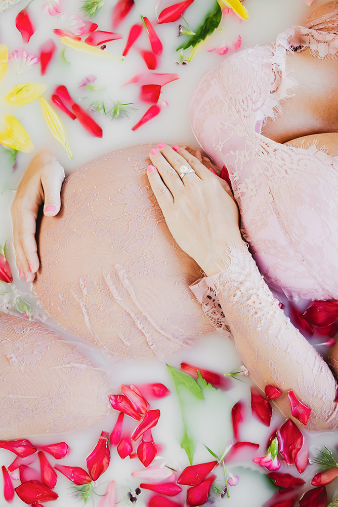 Professional maternity photoshoot Costa Rica – pregnancy belly in milk bath with petals
