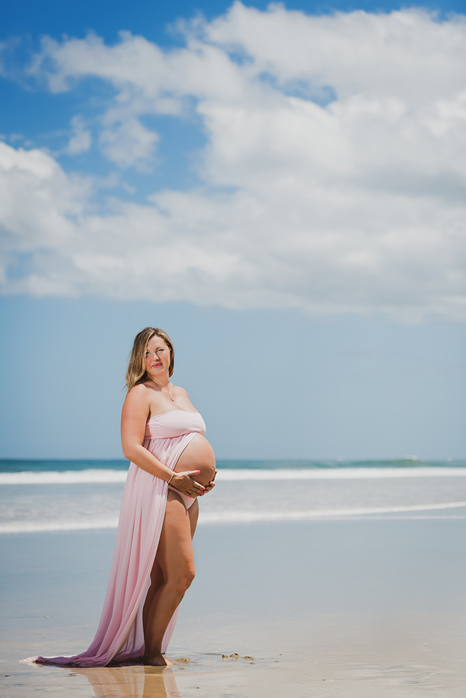 Tamarindo beach maternity portrait – mother-to-be in flowing dress by the ocean