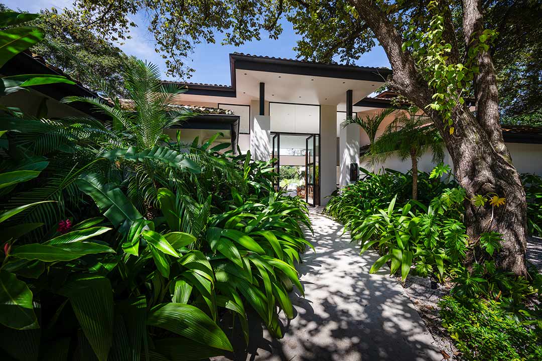 Airbnb rental Tamarindo – modern house exterior with lush greenery