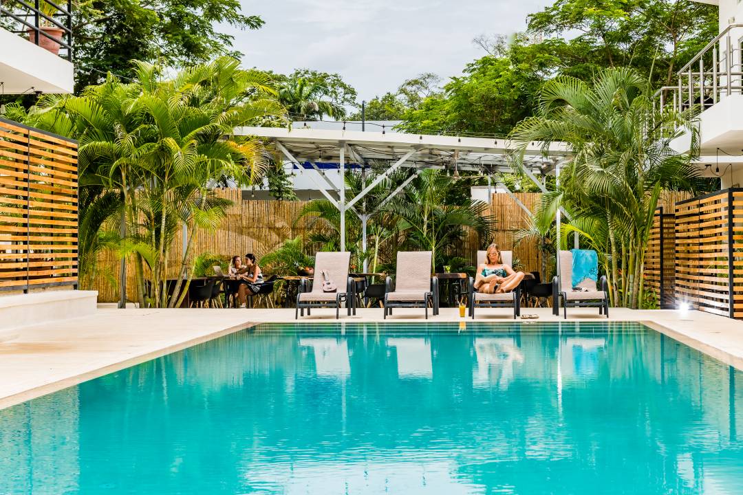 Luxury lifestyle photography Costa Rica – tropical villa with swimming pool and lounge chairs