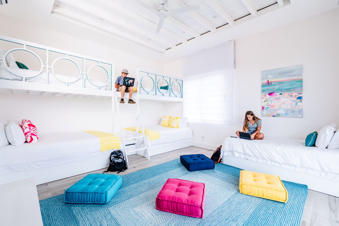 Family lifestyle photography Costa Rica – child relaxing on colorful bed in bright tropical room