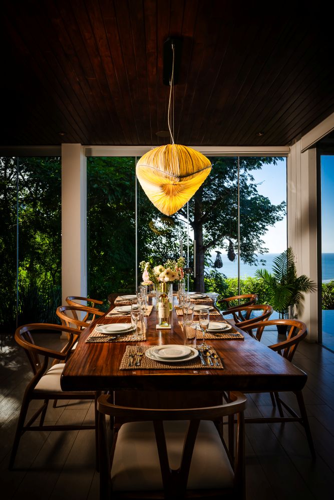 Dining area photography Costa Rica – elegant dining setup with tropical wooden lighting
