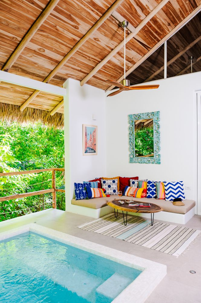 Vacation home lifestyle photography – cozy lounge with pool and tropical greenery